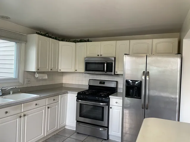 a kitchen with a refrigerator sink and microwave