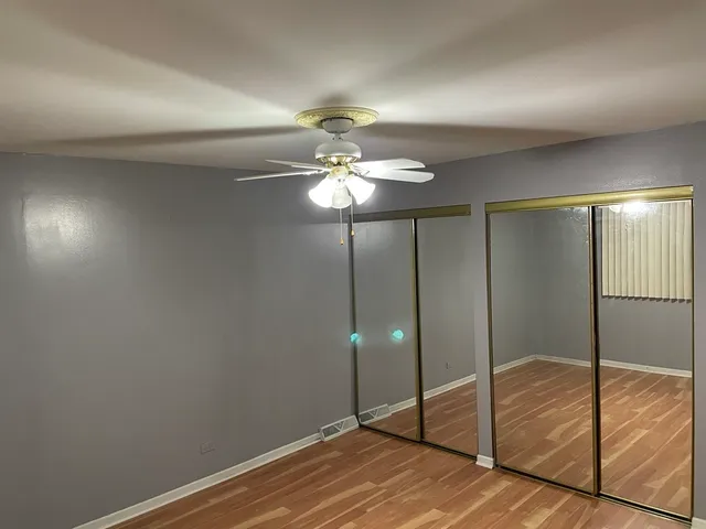 a view of a livingroom with a chandelier fan and a bathroom