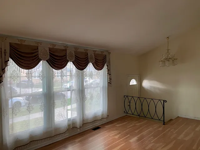 a view of a entryway door with wooden floor
