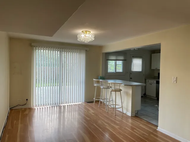 a view of a room with wooden floor and furniture