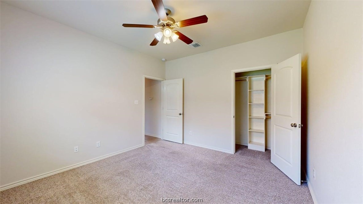 4453-4455 Reveille Road College Station, TX 77845 - Photo 34 of 37 an empty room with closet and a chandelier fan