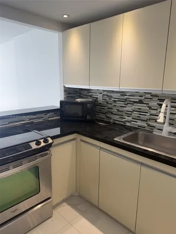 a close view of a stove a microwave and an oven in the kitchen