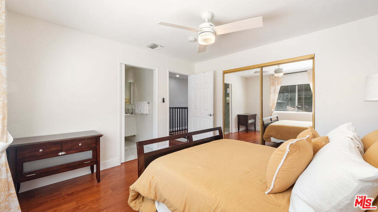 2655 Saxon Drive Los Angeles, CA 90065 - Photo 24 of 40 a bedroom with a bed mirror and a window