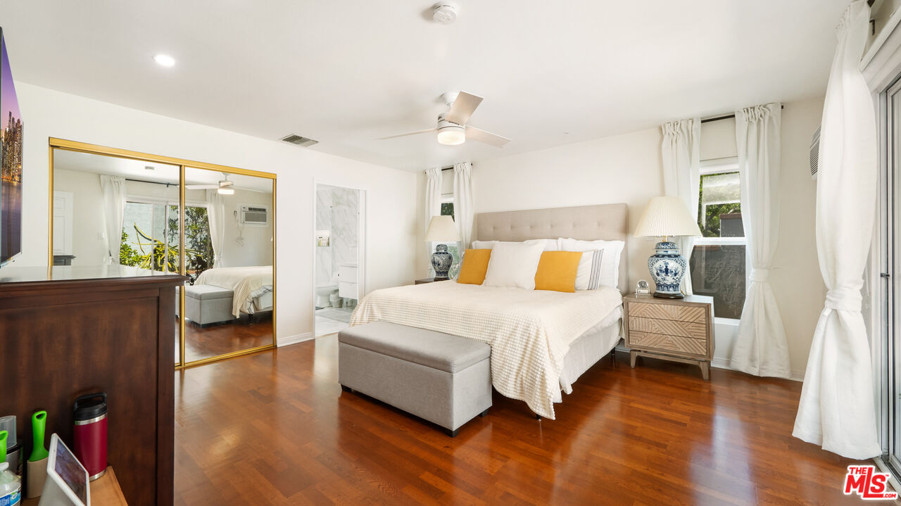2655 Saxon Drive Los Angeles, CA 90065 - Photo 26 of 40 a bedroom with a large bed and wooden floor