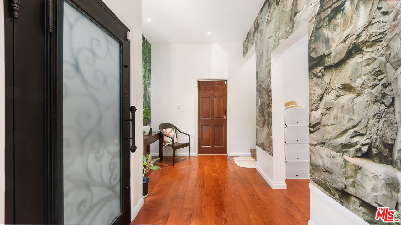 2655 Saxon Drive Los Angeles, CA 90065 - Photo 4 of 40 a view of a hallway with wooden floor and a bathroom