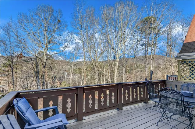 a view of wooden deck and a backyard