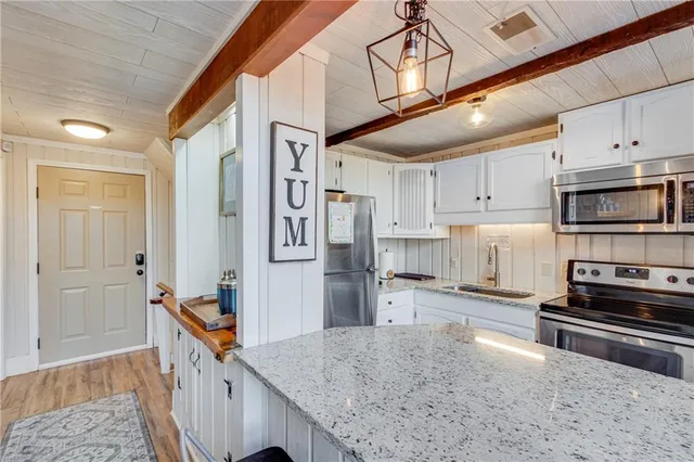 a kitchen with stainless steel appliances granite countertop a stove and a refrigerator