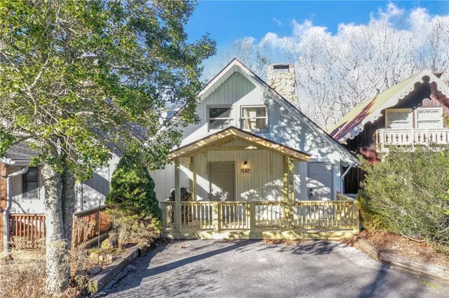 a view of a patio with furniture and a garden