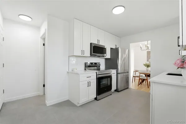 a kitchen with a stove and a refrigerator