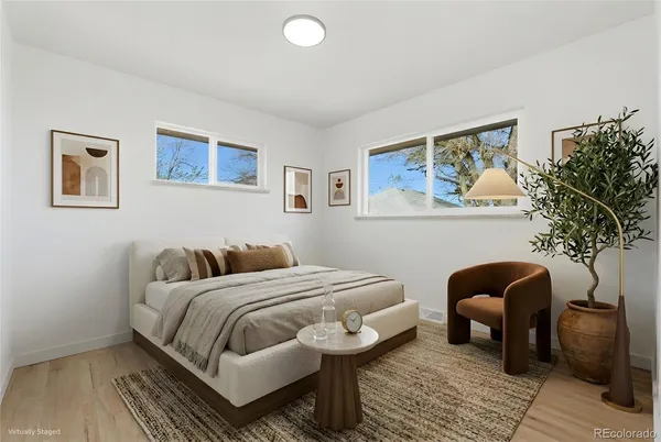 a bedroom with a bed and a couch