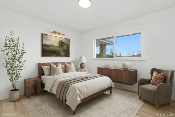 a bedroom with a bed and a couch