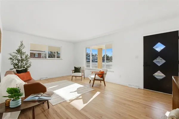 a living room with furniture and wooden floor