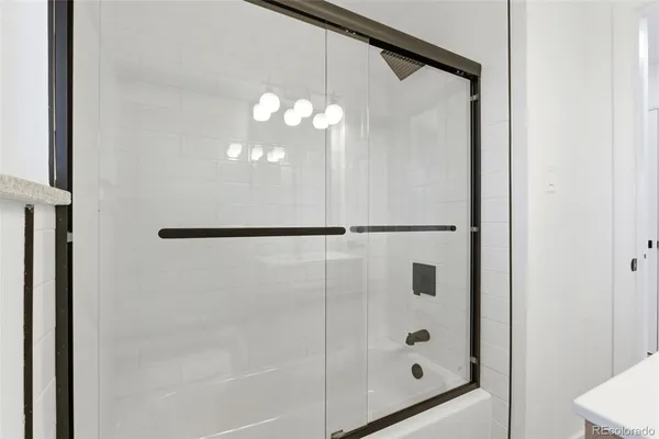 a bathroom with a glass shower door