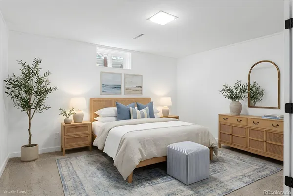 a bedroom with a bed and a potted plant