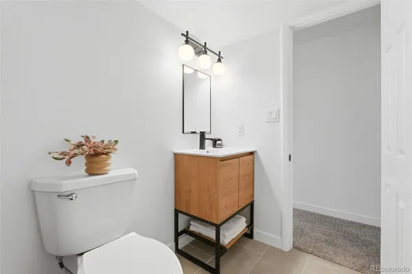 a bathroom with a toilet a sink and mirror