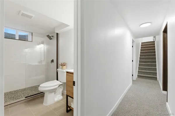 a bathroom with a toilet and a shower