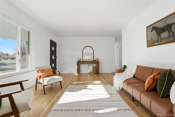 a living room with furniture and a potted plant