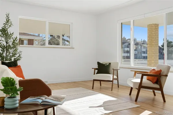 a living room with furniture and a potted plant