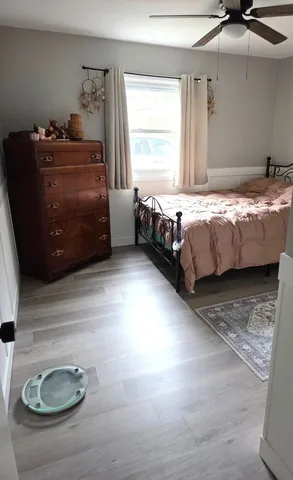 a bed sitting in a bedroom next to a window