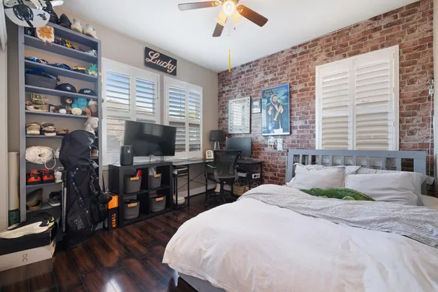 a view of a bedroom with furniture and window