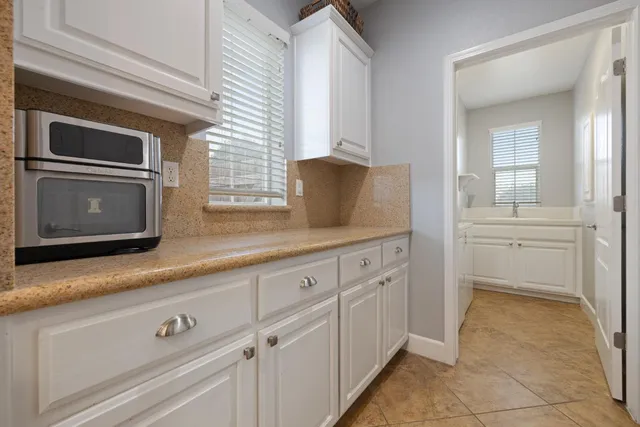 a kitchen with granite countertop a sink stainless steel appliances and cabinets