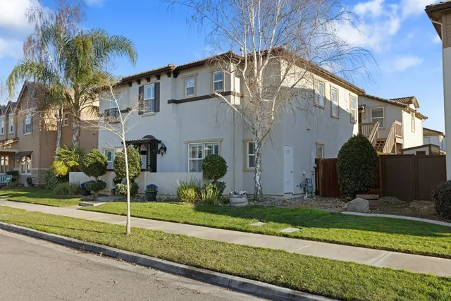 a view of a house with many windows next to a road