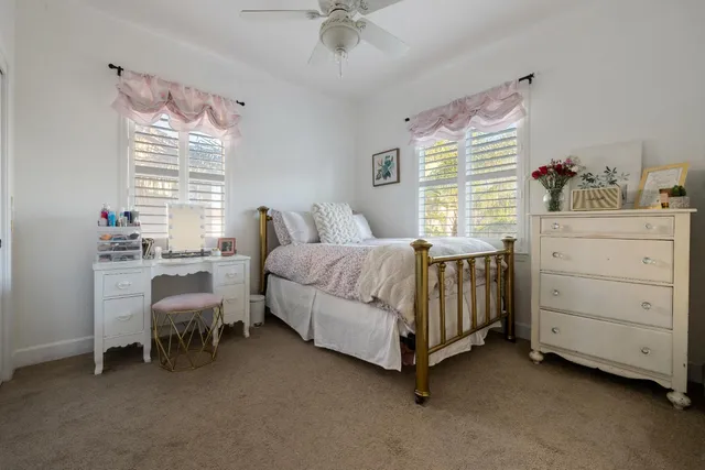 a spacious bedroom with a bed and a chandelier