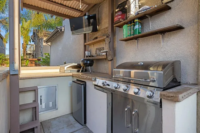 a kitchen with a sink cabinets and wooden floor