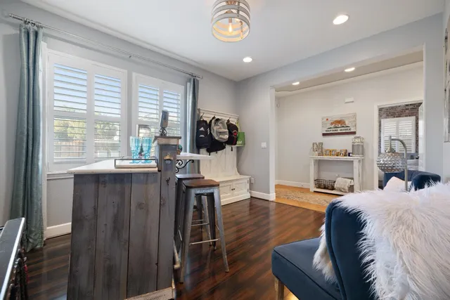 a bedroom with a bed a window and a chandelier