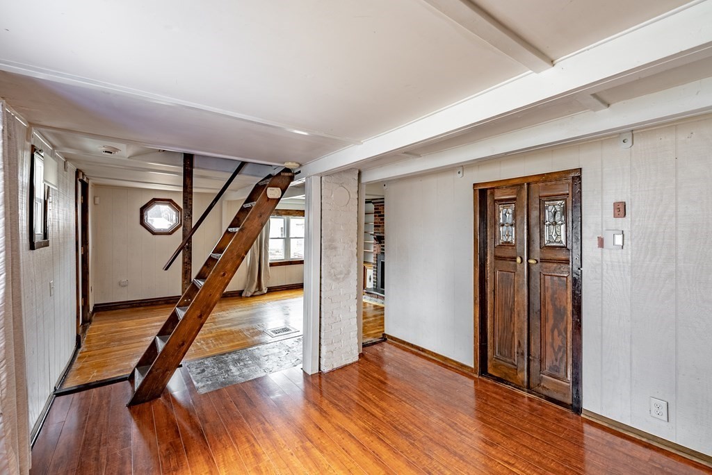 51 Littleton Street Springfield, MA 01104 - Photo 13 of 36 a view of a hallway with wooden floor and stairs