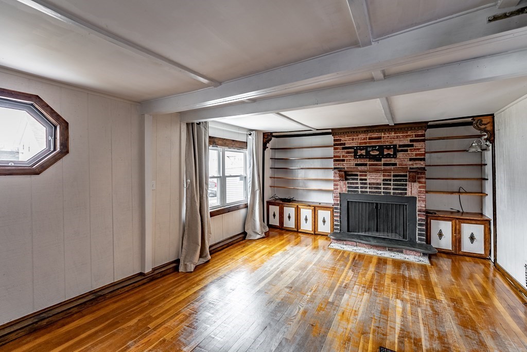 51 Littleton Street Springfield, MA 01104 - Photo 9 of 36 a view of a livingroom with a fireplace and window