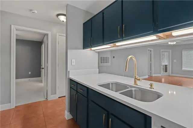 a kitchen with a sink and cabinets
