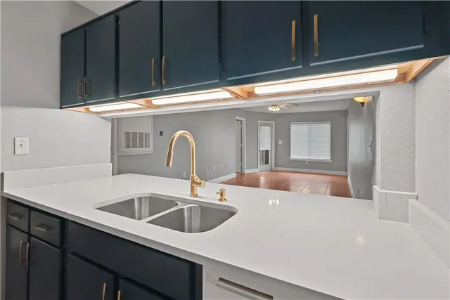 a kitchen with stainless steel appliances granite countertop a sink and a stove