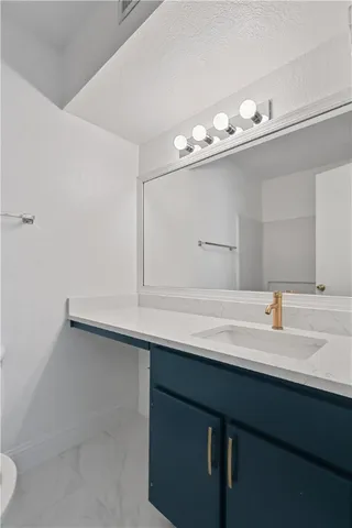 a bathroom with a toilet a sink and bathtub