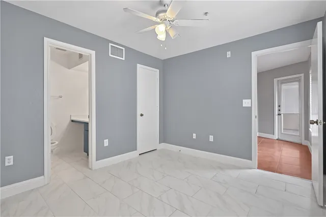 a view of an empty room with a ceiling fan