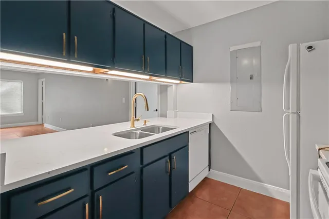 a kitchen with a sink cabinets and window