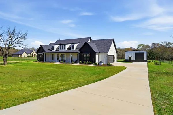 a front view of house with yard and green space