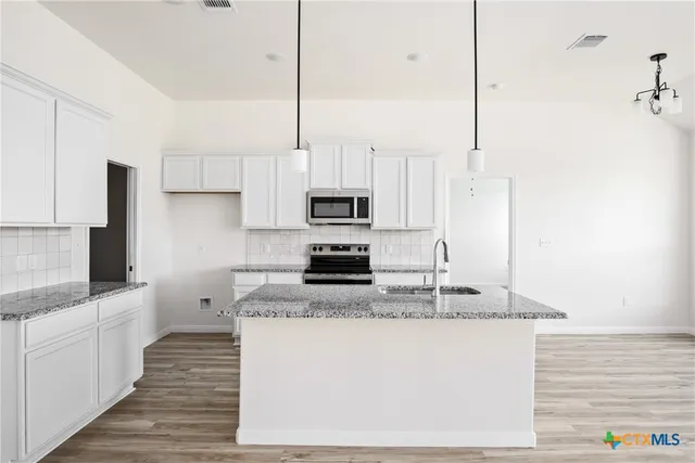 a kitchen with a stove and a microwave