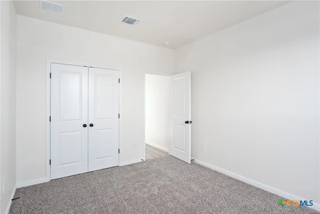 a bathroom with a granite countertop sink a toilet and a mirror