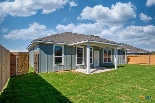 a view of a house with a yard and sitting area