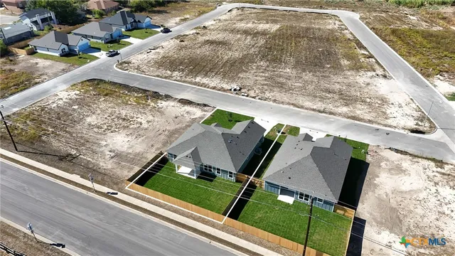 a view of swimming pool with a garden and plants
