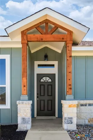 a kitchen with stainless steel appliances kitchen island wooden floors granite counter tops and a window
