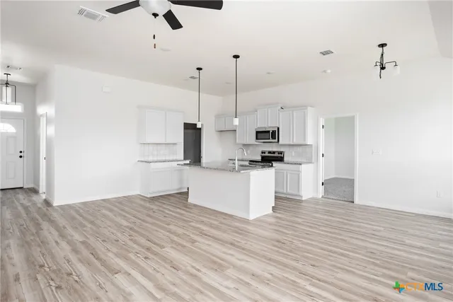 a kitchen with a sink and cabinets