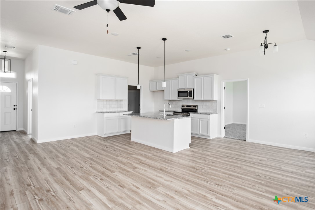 1013 Lago Azul Lane Temple, TX 76504 - Photo 10 of 32 a view of kitchen with refrigerator microwave and stove top oven