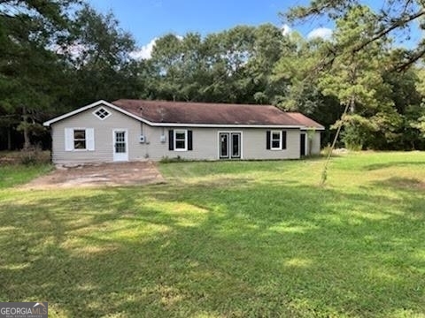 721 Fulton Road Northeast Kingston, GA 30145 - Photo 1 of 1 a view of a house with a big yard and large trees