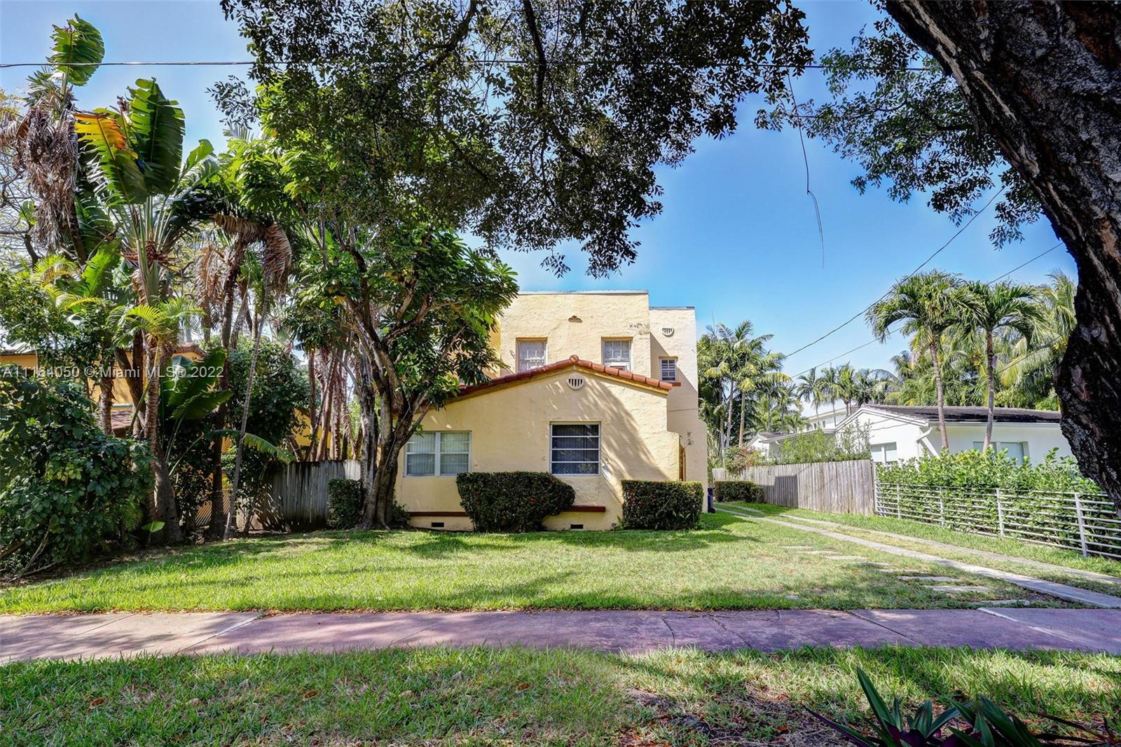 a view of a house with a yard and a garden