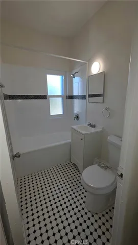 a bathroom with a toilet a sink and a mirror