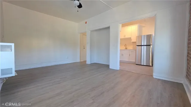 an empty room with wooden floor and a window