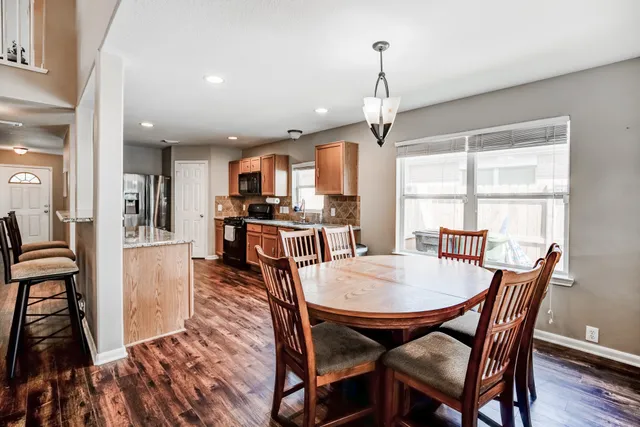 a view of a dining room with furniture window and wooden floor