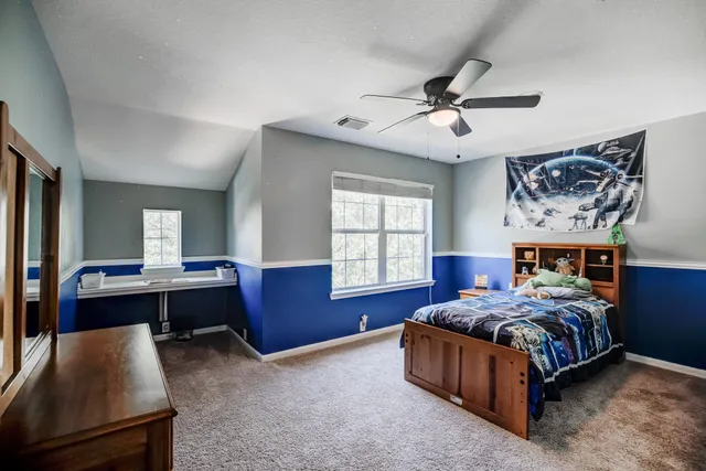 a bed room with a bed and a window